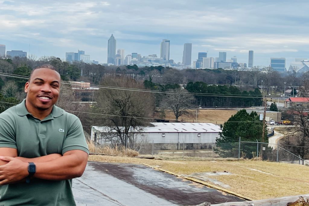 Man stands outside smiling