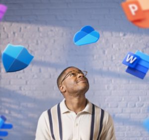 Man looking up as icons of Microsoft 365 programs float around him