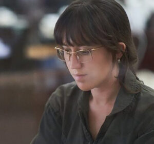 Woman wearing glasses looks at her computer screen