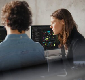 Two people looking at computer screens