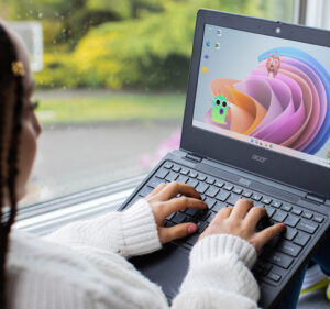 Girl interacting with an educational app on her laptop computer
