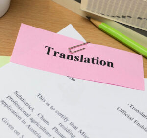 Stack of papers attatched with a paper clip to a label marked translation