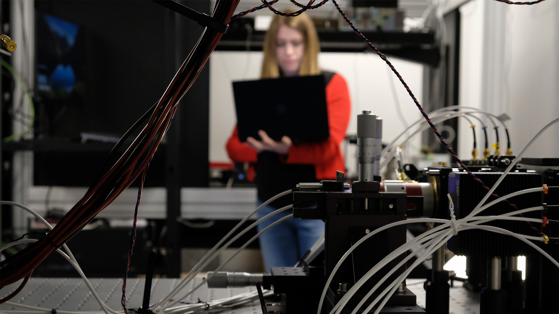Grace Brennan surrounded by computer equipment and wires