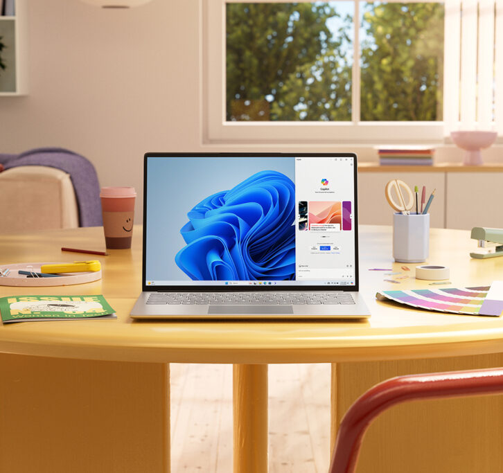 Laptop running Windows Copilot on a living room table with creative tools