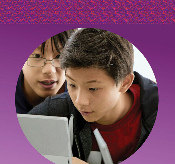 Two students working together on a laptop computer