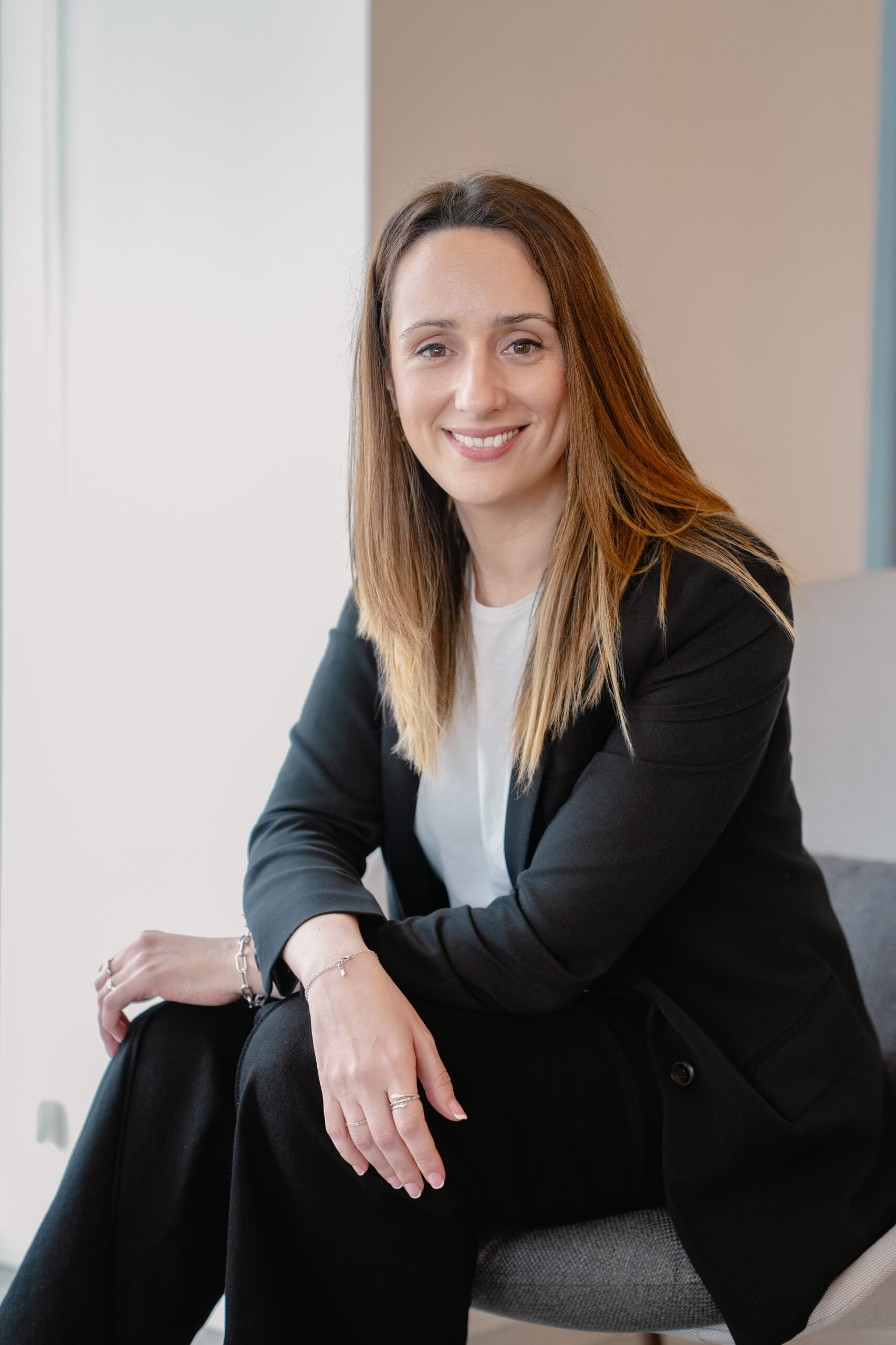 Woman sitting with crossed legs smiling