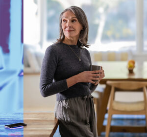 Woman standing holding a coffee cup