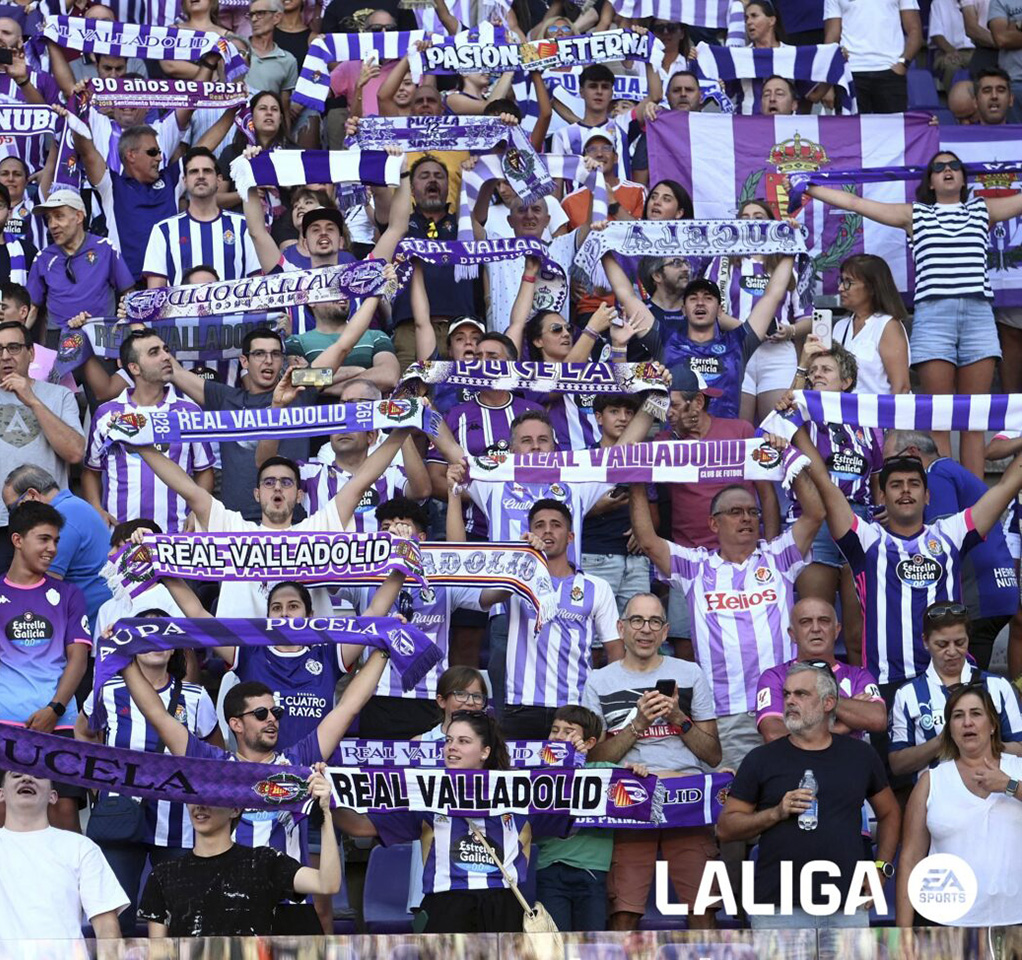 Soccer fans holding up signs in a stadium