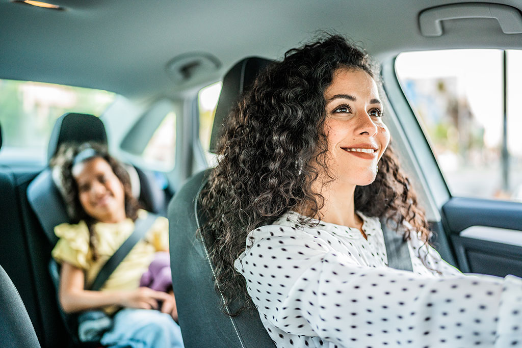 Adult driving in the car with a child