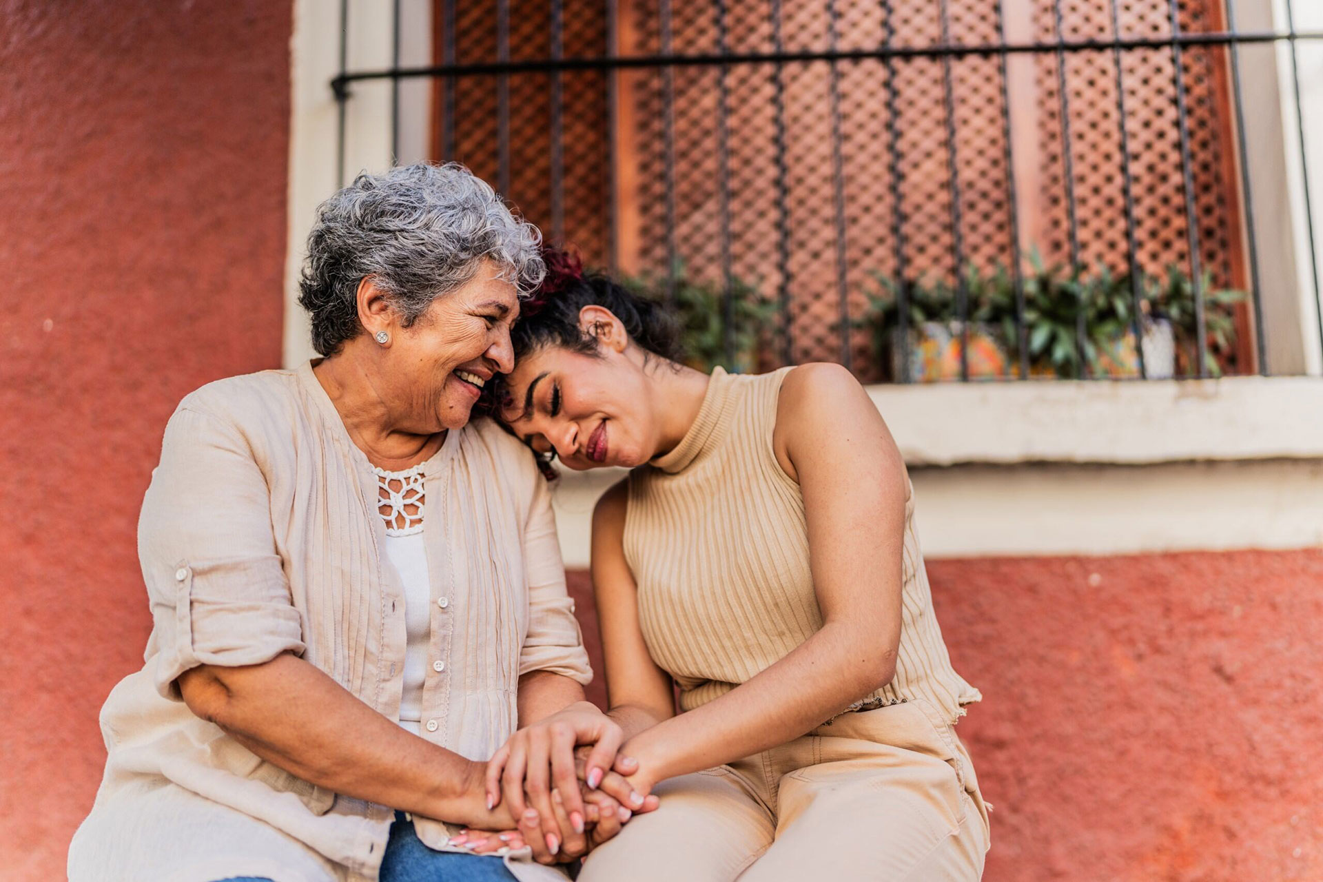 Two adults embracing leaning together