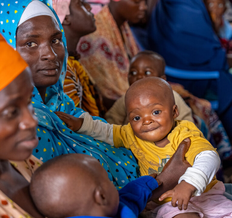 Mothers in Africa holding babies.