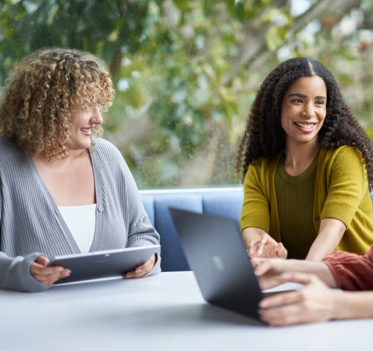 Three people meeting at a table.