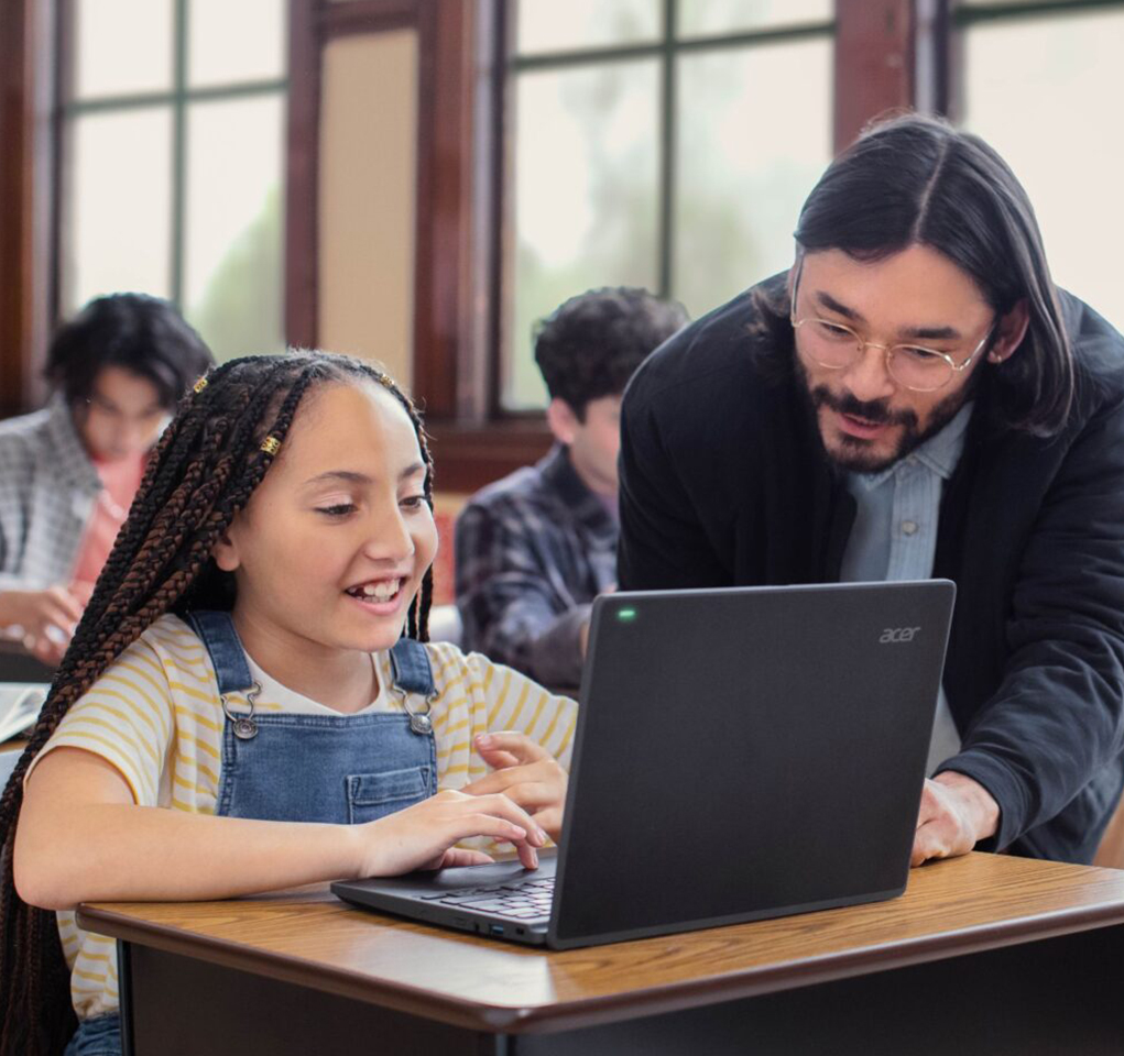 Teacher and student working together in a classroom.