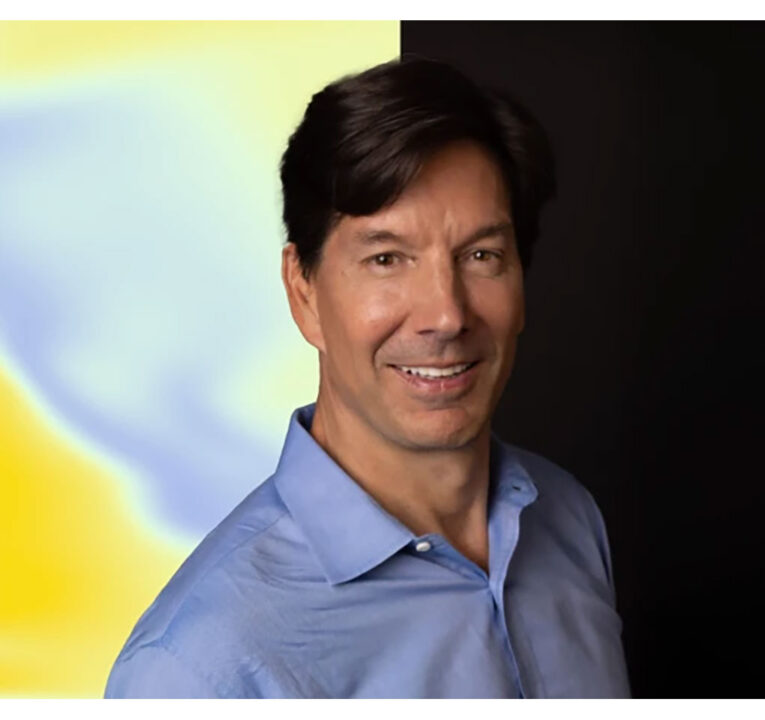Man smiling for a portrait photo.