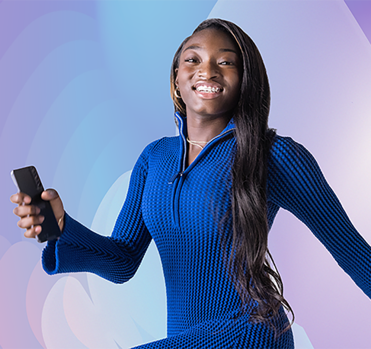 Woman walking in mid stride holding a phone.