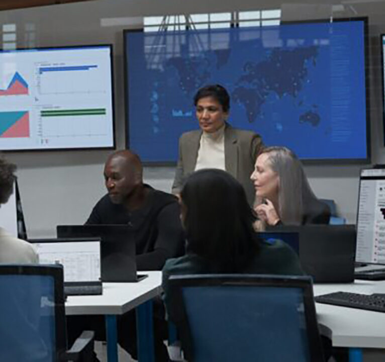 Four people in a security operations center.