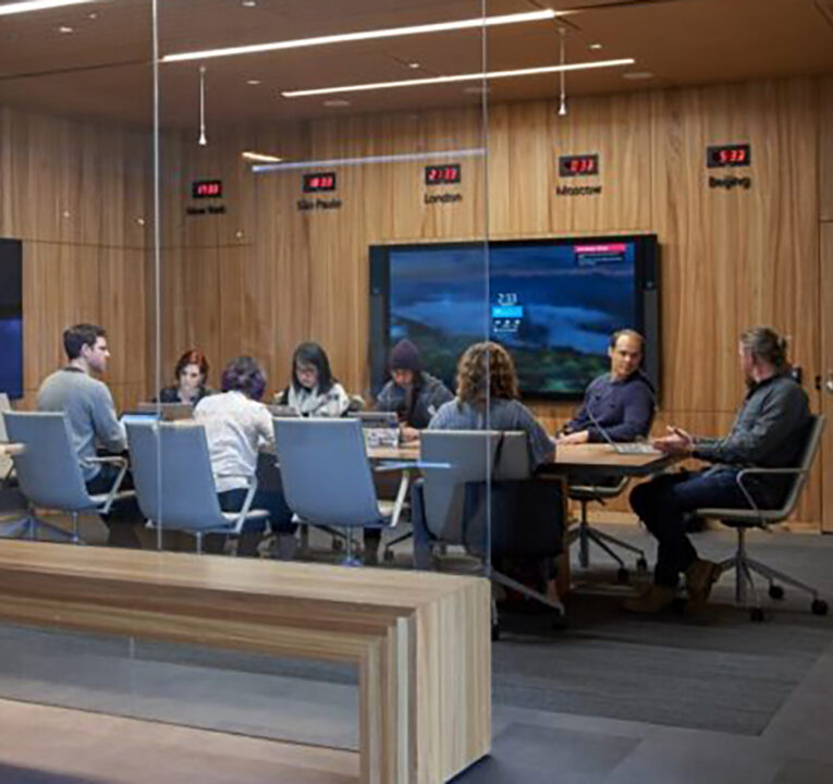 Eight people seated around a large conference table.