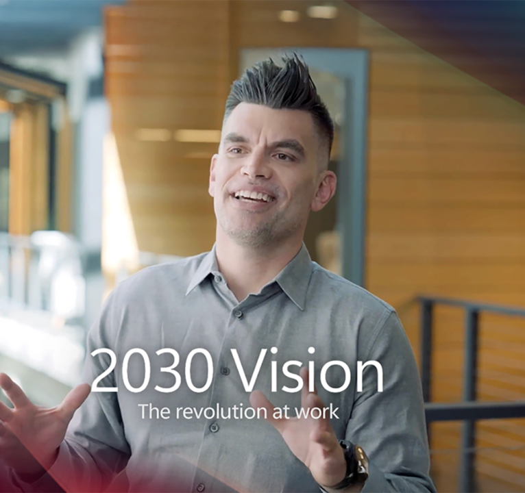 A man talking, with text overlaid reading 2030 vision, the revolution at work.